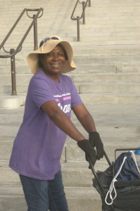 old Afician Americn smiling lady pushing a cart and happy as a bee