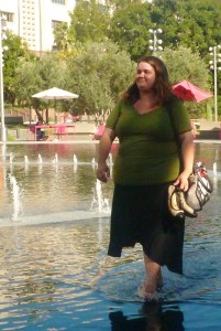 20 something female walk bare footed thru water at grand Park fountain in downtown LA