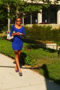 Africian Amercian in lovely blue dress with match shoes walks down Hill Street
