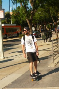 20 somehting amn cruises on skateboard on Hill street near Red Line subay