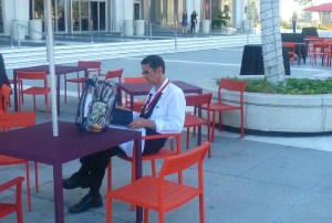 waiter sits at waiting relaxing outside in downtown LA