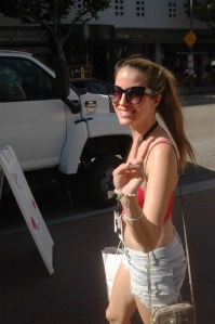 beautiful woman walks in downtown LA afterphoto Slutwalk, gives the peace sign