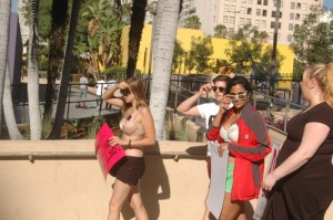 few girls walk out of slutwalk, with si=unglasses