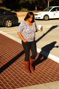 african amercian middle aged female walk with coffee and phone in hnad