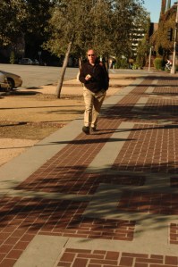 mid aged man stroll down street with sunglasses on Pasadena CA