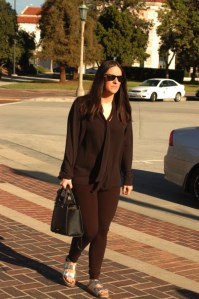late twenty something female slowly walks down the street to Pasadena City Hall