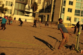 young man balances self in rope Santa Moonica CA