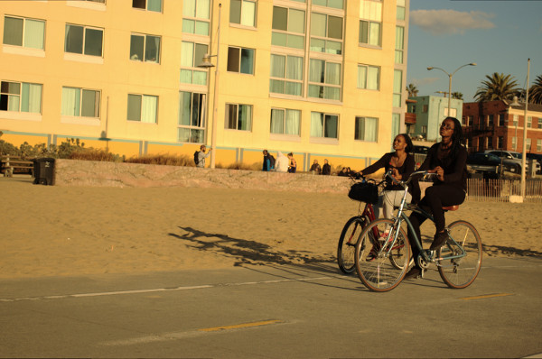 2 African American women rides bikes Santa Monica CA baclk friday 2015