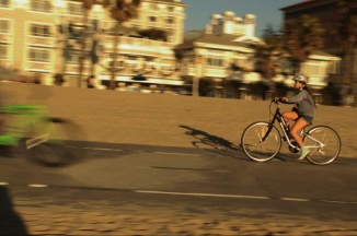 young girl rides a bike at the beach in Santa Monca CA