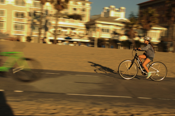 young girl rides a bike at the beach in Santa Monca CA