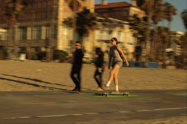 teen skateboard at Santa Monca berach panning image