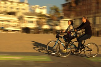 2 mi=ddle aged woman ride bikes at pedestrain way Santya Monica CA