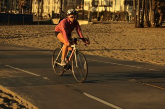 attractive female rides a bike in pink top