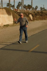 colorful man smiles and waves with sunglasses on