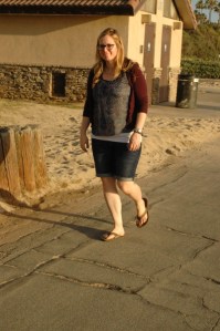girl in sandals walks along path at beach