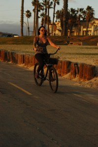 attractive 20 something female bikes at the beach