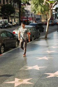 single fit 20 something male walks on VIne, in Hollywood, CA