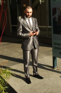 sharply dressed 20 something man with vapor cig & I phone