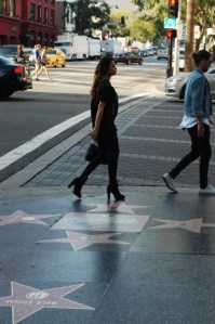 side profile of attractive female in heels and another female in tennis shoes Hollywood Bvld