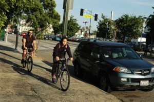 young hispanic couple bike down Hollywood blvd