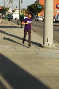 20 something male jogs on Hollywood Blvd