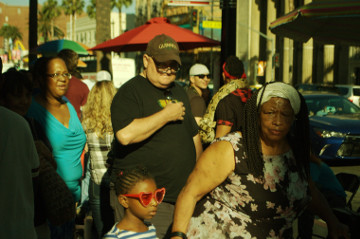 crowsd scene with older female with young daughter on red fancy glasses
