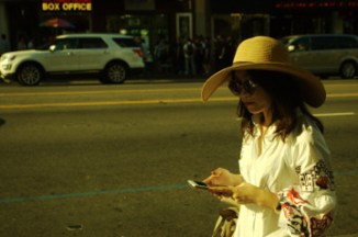 attractive young Asian American in large hat