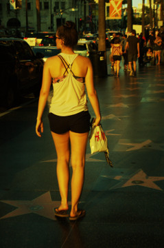 attractive young female in summer clothes strolls Hollywood