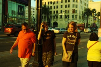 family looks at stars on Hollywood Blvd