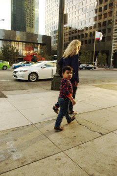 mom walk with son that stares at the camera