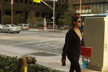 hispanic attractive woman walks on Flower St