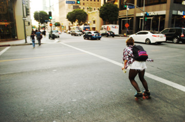 attractive female on roller skates rolls down Flower St