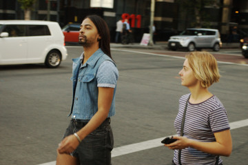 attractive blonde look at man with long hair crossing intersection