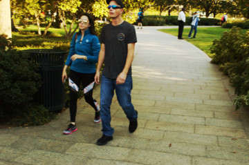 attractive & young Asain couple with sunglasses walk ofout garden Mall area