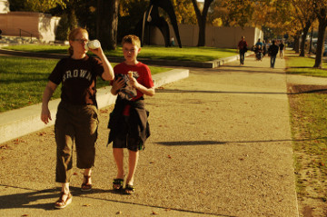 mom and son walk drinking water at Mall