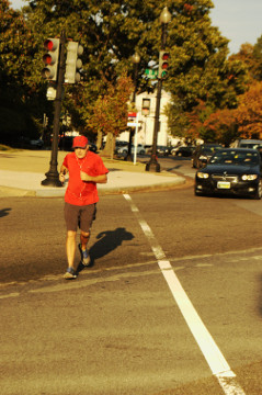 man in red shirt jogs away from Union Station