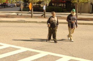 Baltimore 31 Oct 16 inner harbors 2 older guys cross street with canes