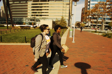 Baltimore 31 Oct 16 inner harbor 2 attractive African American women walk
