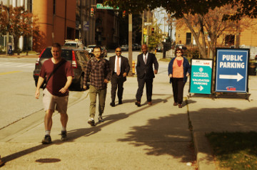 Baltimore 31 Oct 16 inner harbor men in suits and regulars walk to inner harbor