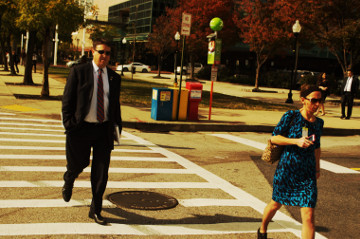 Baltimore 31 Oct 16 inner harbor man in suit and female cross the street