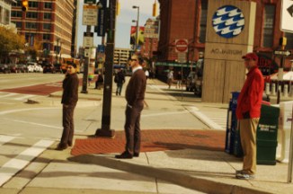 Baltimore 31 Oct 16 inner harbor 3 men wait to cross te street